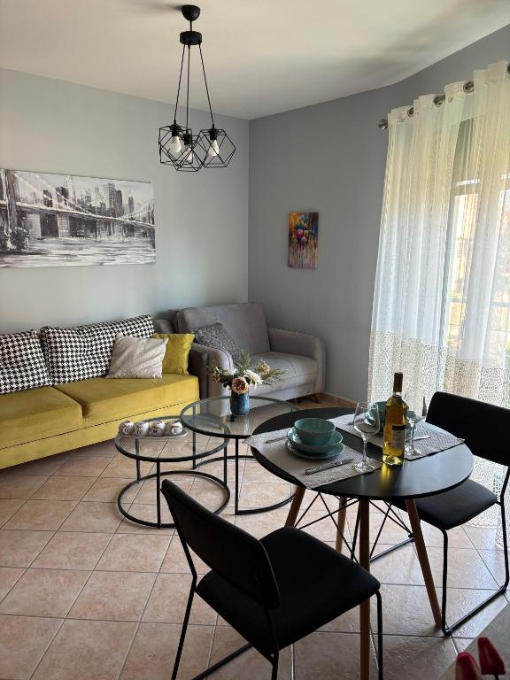 a living room with two tables and a couch at Thetis I in Alexandroupoli
