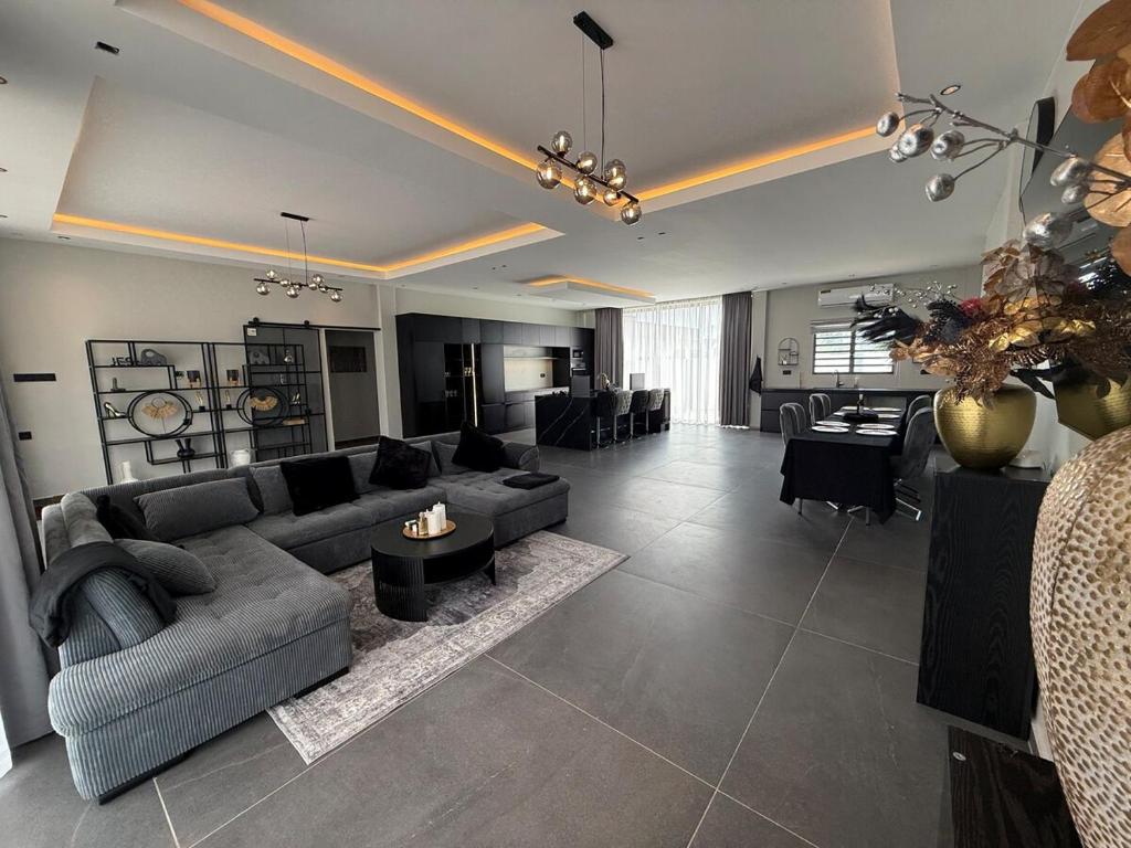 a living room with a couch and a table at Boa Vista villa in Paramaribo