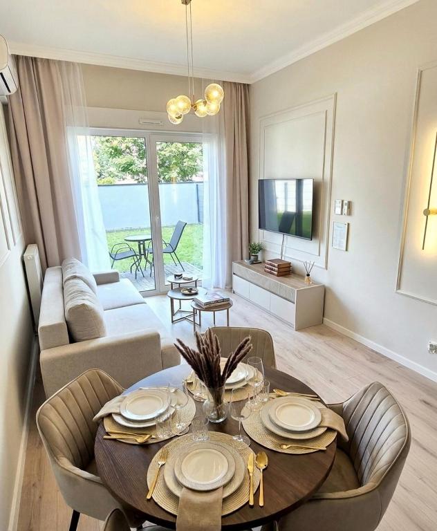 a living room with a table and a couch at STARCO Apartamenty Centrum in Stargard