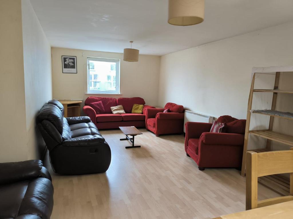 a living room with two red couches at Salthill Gem in Galway