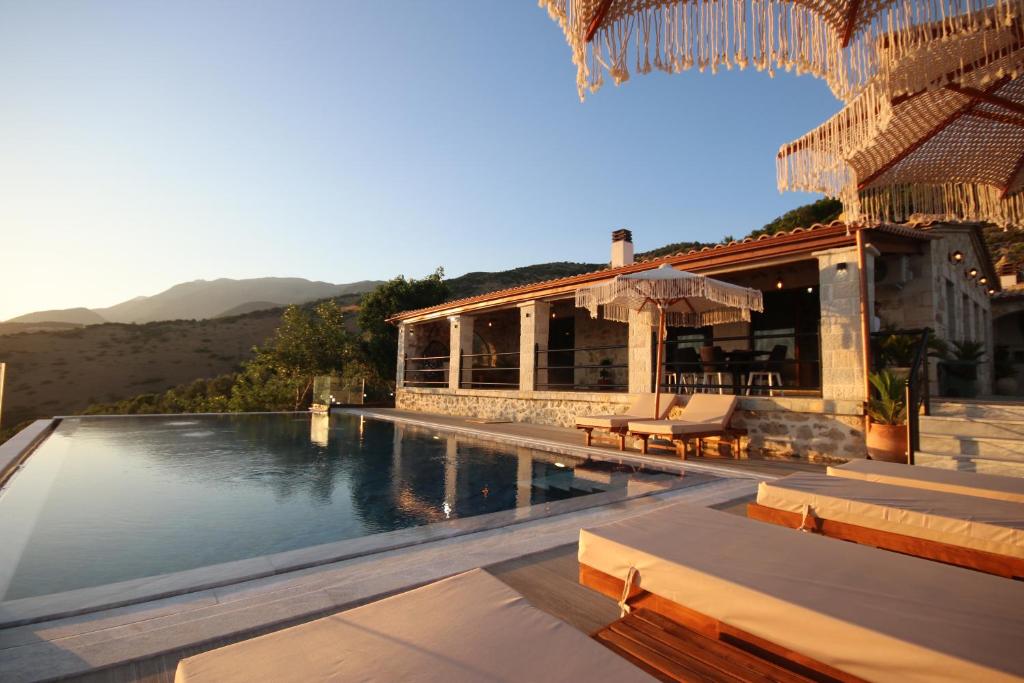 a resort with a swimming pool and a building at Villa ACROPOLIS in Jal