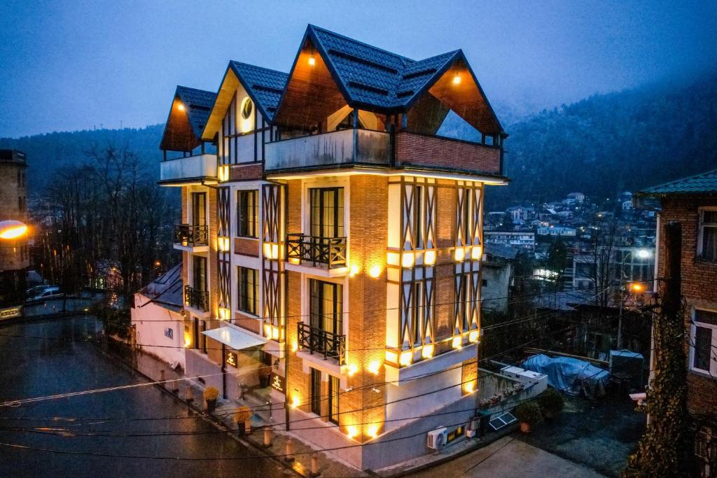 a large house with lights on the side of it at 1 Hotel Borjomi in Borjomi