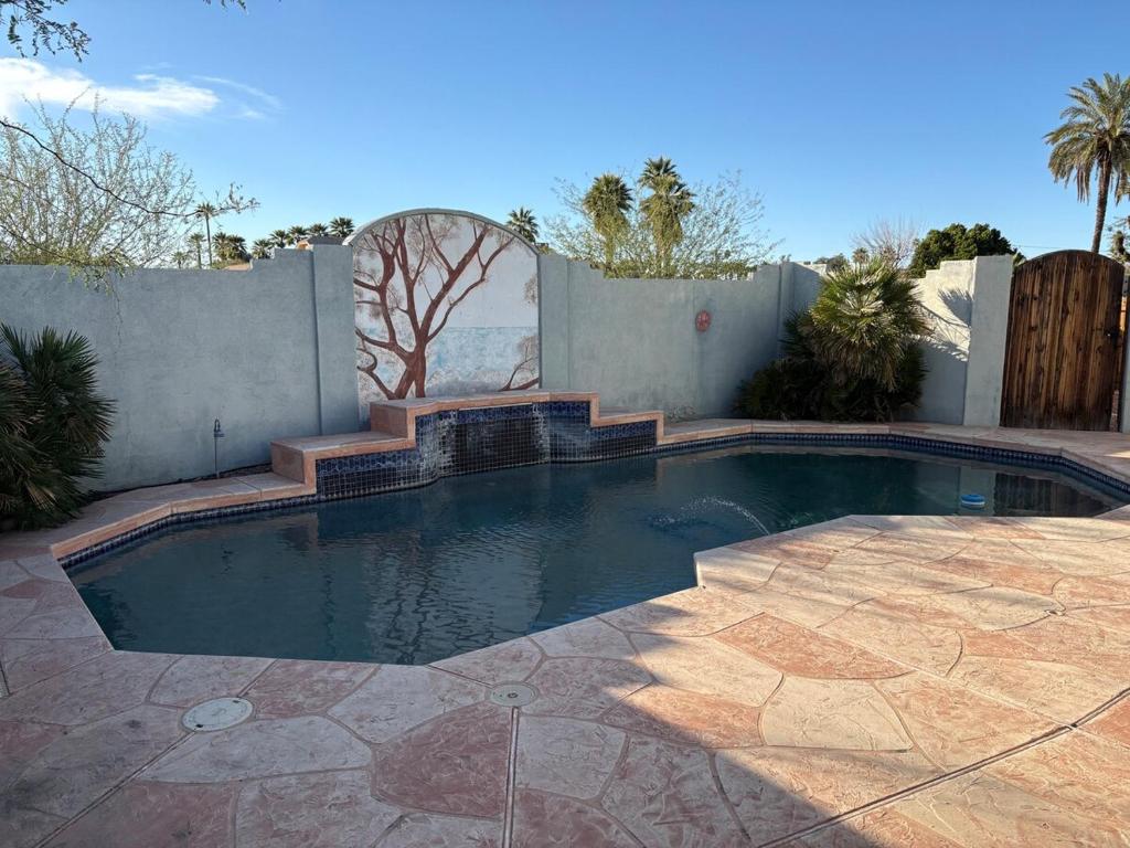a small swimming pool in a backyard with a fence at CRYStALZ pool studio kitchen DWNtWN stadiums arts in Phoenix