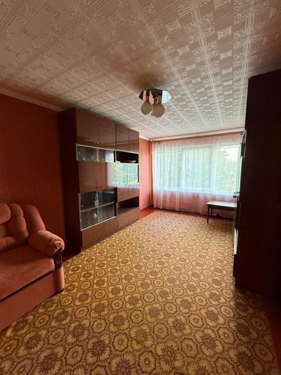 a living room with a couch and a table at Apkalna Retro Apartment in Ventspils