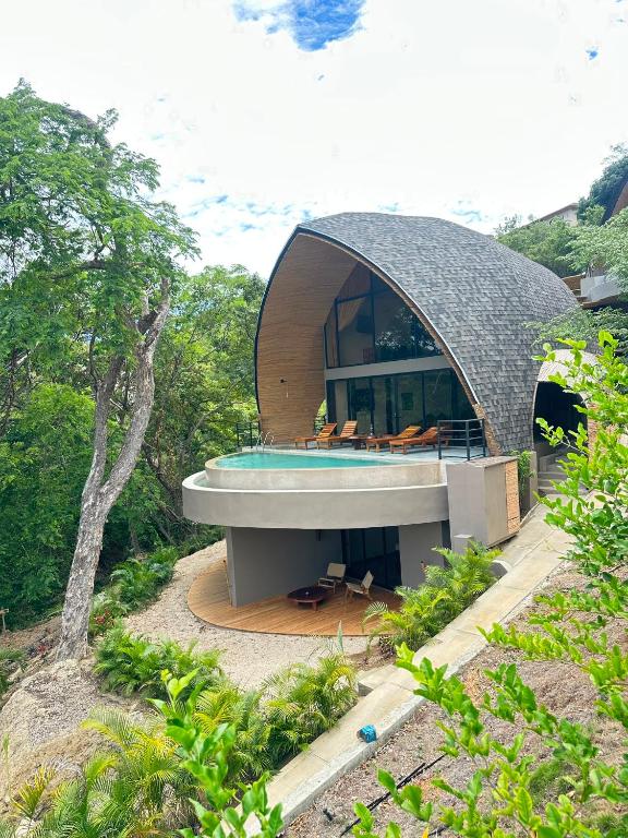 a circular house with a pool in the middle at Villa Green Diamond in Playa Flamingo