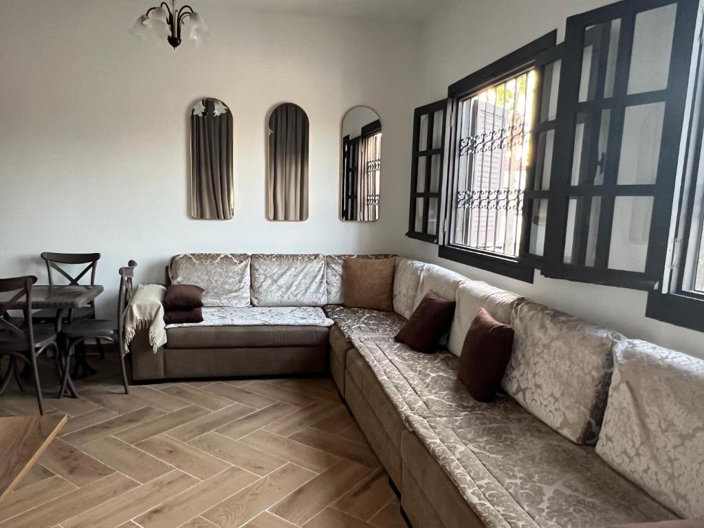 a living room with a couch and a table at Casa Mouna in Cabo Negro