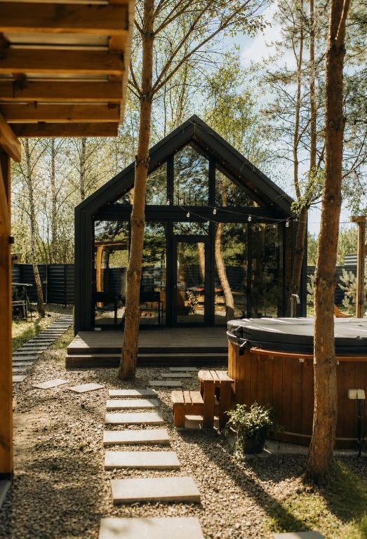 a pavilion with a hot tub in a forest at Forest Vibe Hotel&Spa in Kulʼchin