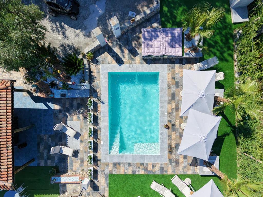 an overhead view of a swimming pool with umbrellas at Paradise House in Maratea