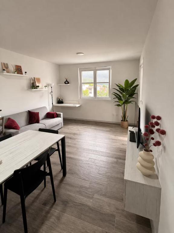 a living room with a table and a couch at Civico27-modern apartment in Sondrio in Sondrio