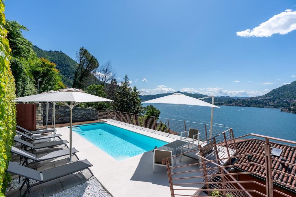 a swimming pool with a view of the water at Luxury Como Lake - Luxury Villa with Infinity Pool in Blevio