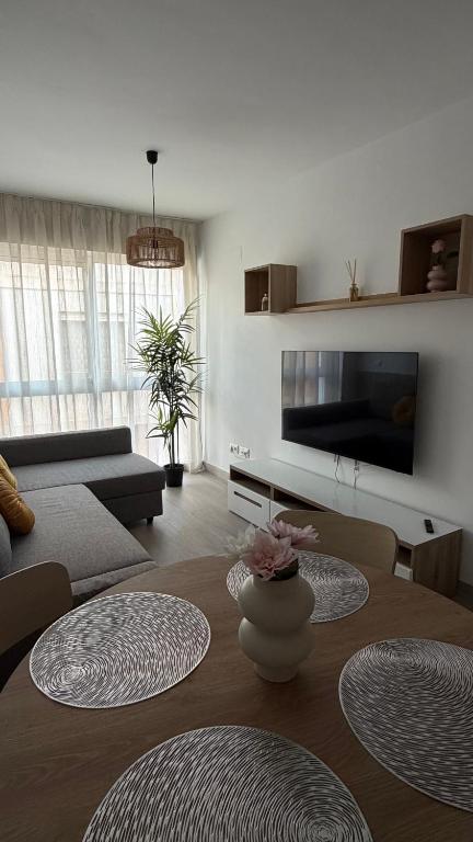 a living room with a table and a couch at Apartamentos FELIP 2 in Burriana