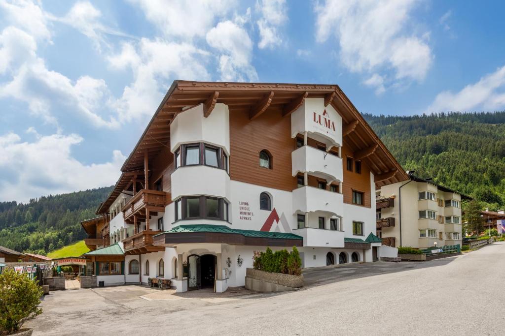 a hotel in the middle of a road at LUMA Stubai Aparthotel - Neueröffnung inklusive STUBAI SUPER CARD in Neustift im Stubaital