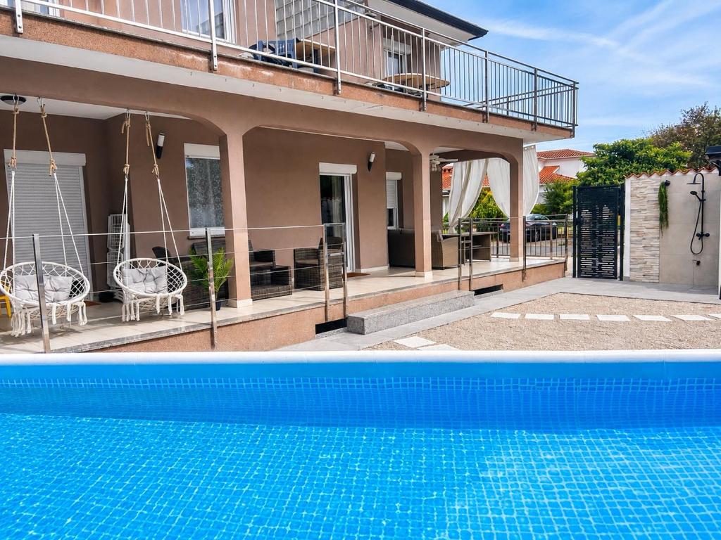 two pictures of a house and a swimming pool at Zen Suite in Umag