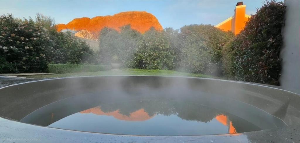 a pool of water in a window with a reflection at C'est la Vie 1 Self-catering apartment with private hot tub in Franschhoek