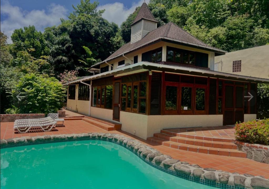 a house with a swimming pool in front of a house at coubaril Manor in Castries