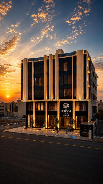 a large building with a sunset in the background at LEGooT HOTEL in Khamis Mushayt