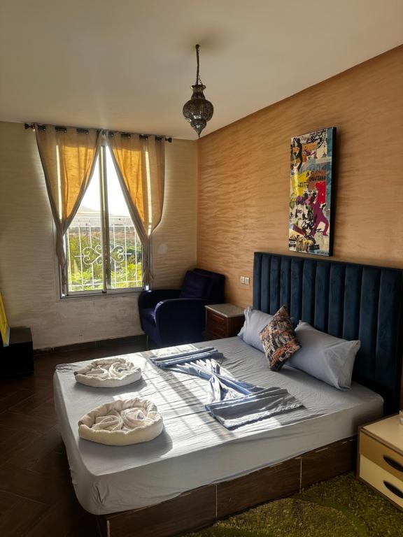 a bedroom with a bed and a couch and a chair at Ouzoud le Panorama in Ouzoud