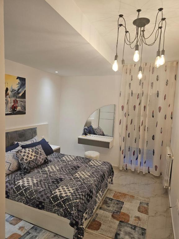 a bedroom with a bed and a climbing wall at Nading flat in 'Aïn Benian