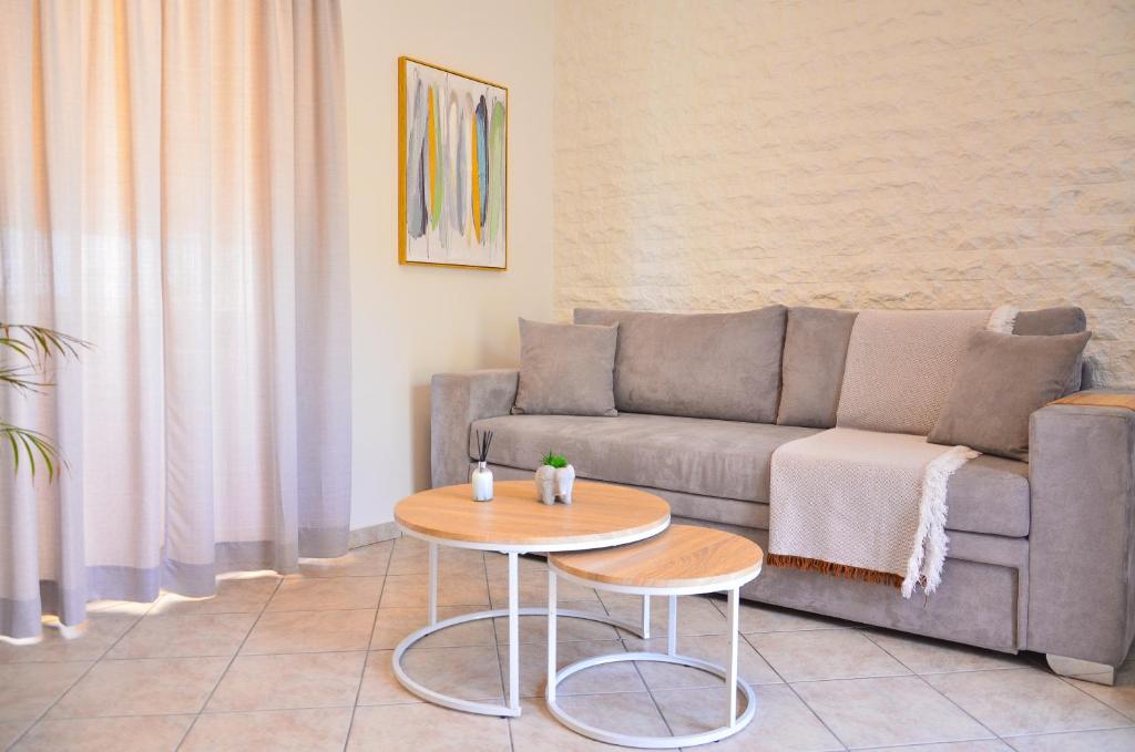 a living room with a couch and a table at Angie's Serenity Apartment in Vathí