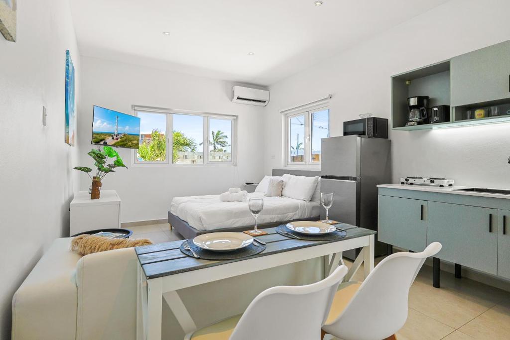 a living room with a couch and a table and chairs at Villa Sirena Azul Apt 1 in Palm-Eagle Beach