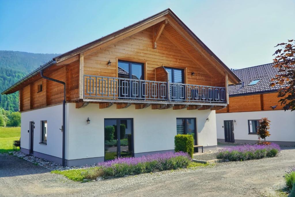 a house in the mountains with a balcony at Nassfeld Holiday Home in Rattendorf