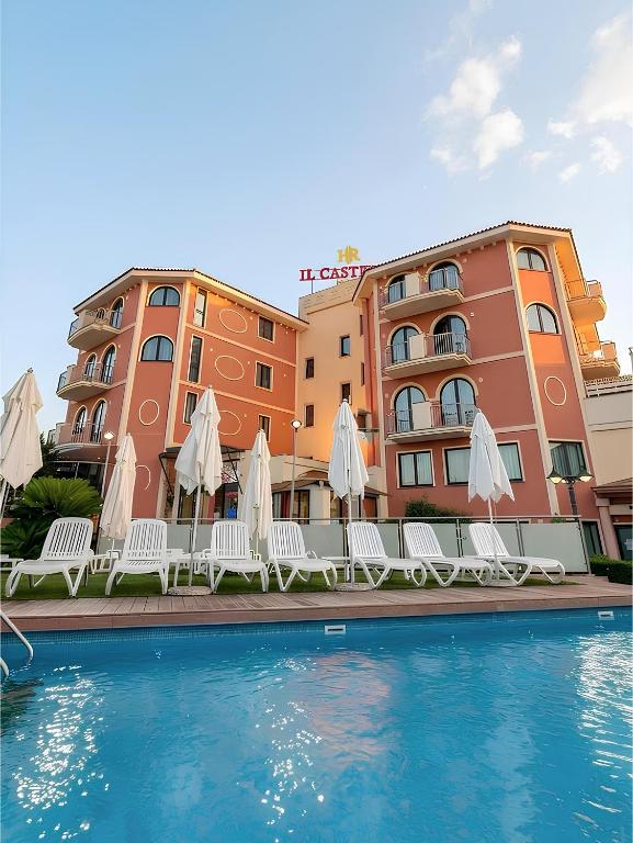 a hotel with a swimming pool in front of a building at Il Castello in Terzigno