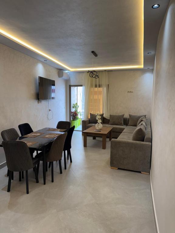 a living room with a couch and a table and chairs at اقامة هبة 4 in Yebha