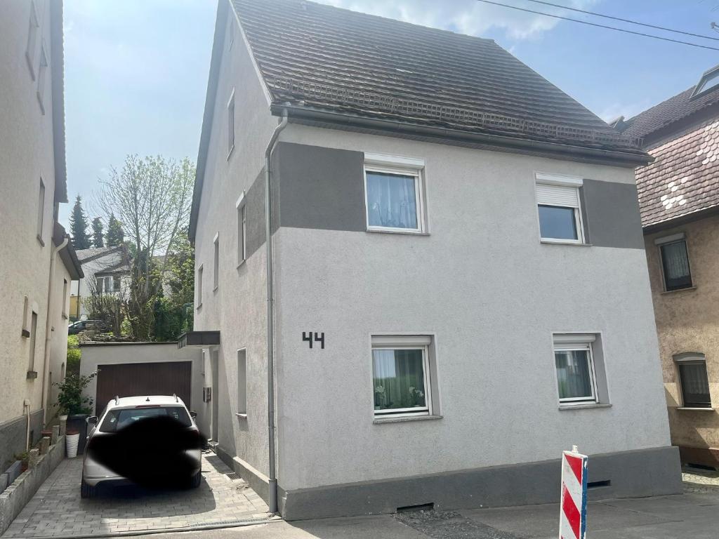 a house with a car parked in a driveway at Zimmer heilbronn in Heilbronn
