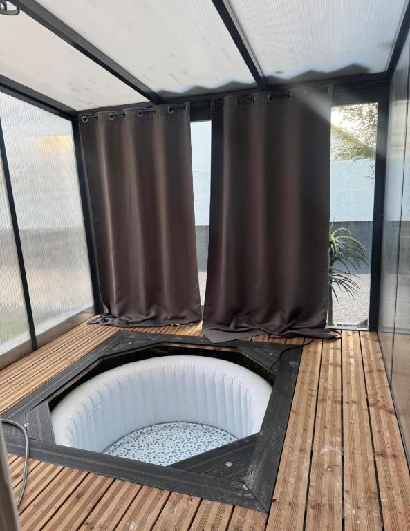 a gazebo with a shower on a deck at les gîtes de la Colombière 10 personnes in Longvic