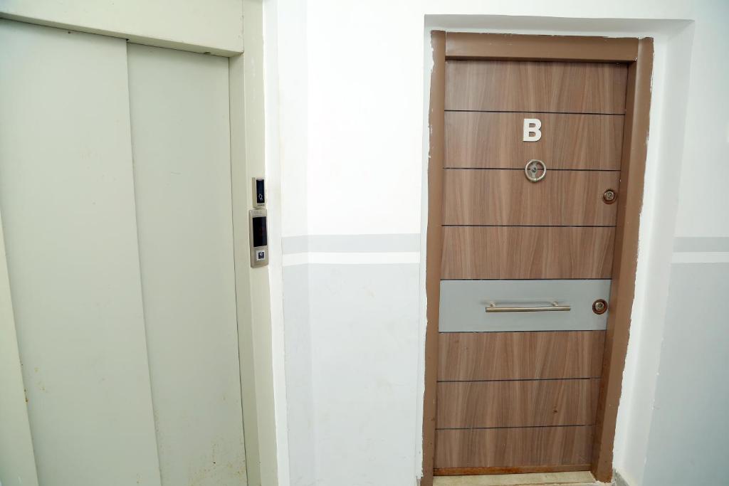 a wooden door with the letter b on it at Winner house in Oran