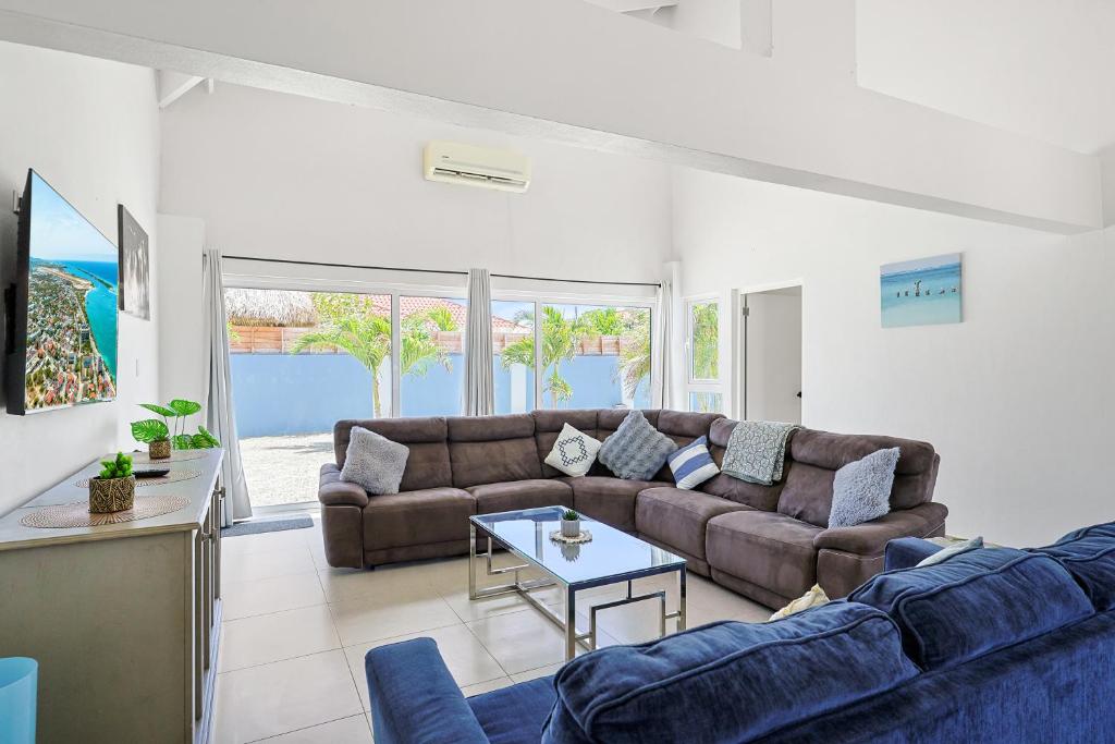 a living room with a couch and a table at Villa Sirena Azul Apt 2 in Palm-Eagle Beach