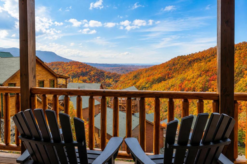two chairs on a porch with a view of the mountains at Hibearnator in Sevierville