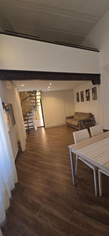 a room with a table and chairs and a couch at G & N Luxury House in Lecce