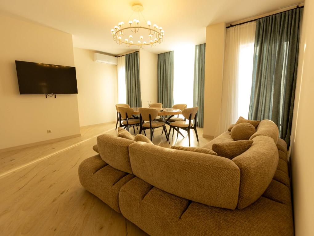 a living room with a couch and a table at Mos House in Kobuleti