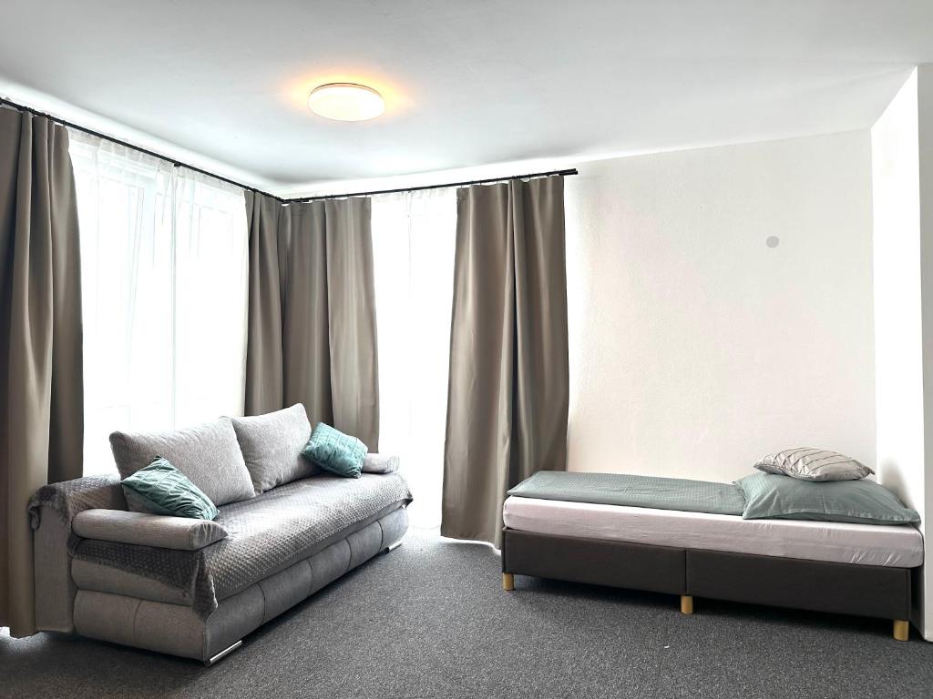a living room with a couch and a bed at Modernes Studio mit Küche, WLAN, Parkplatz in Dingolfing