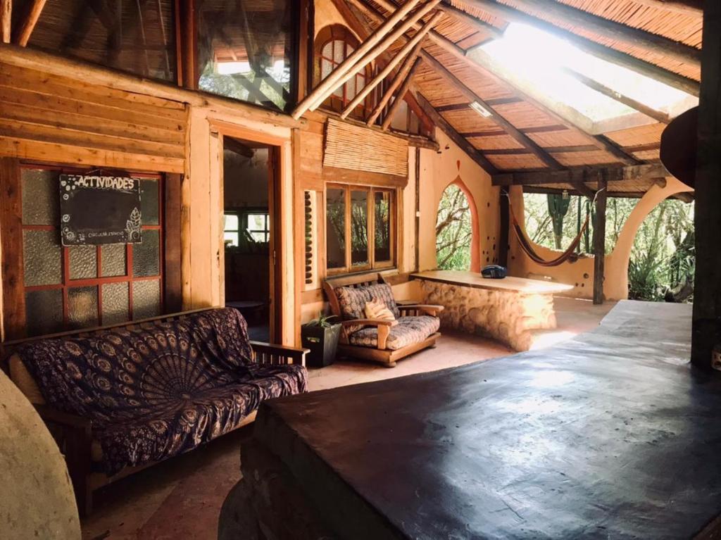 a large living room with couches and a table at Espacio Circular Eco Hostel in San Marcos Sierras