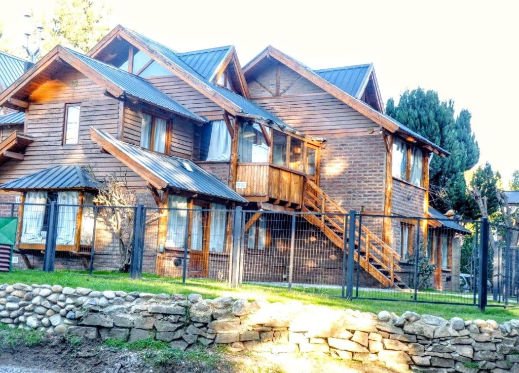 a wooden house with a fence in front of it at Carreño Andino in San Carlos de Bariloche