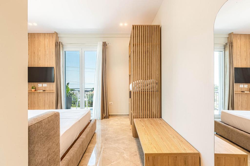 two views of a bedroom with a bed and a tv at New Dhermi Icon 2 - Parking in Dhërmi
