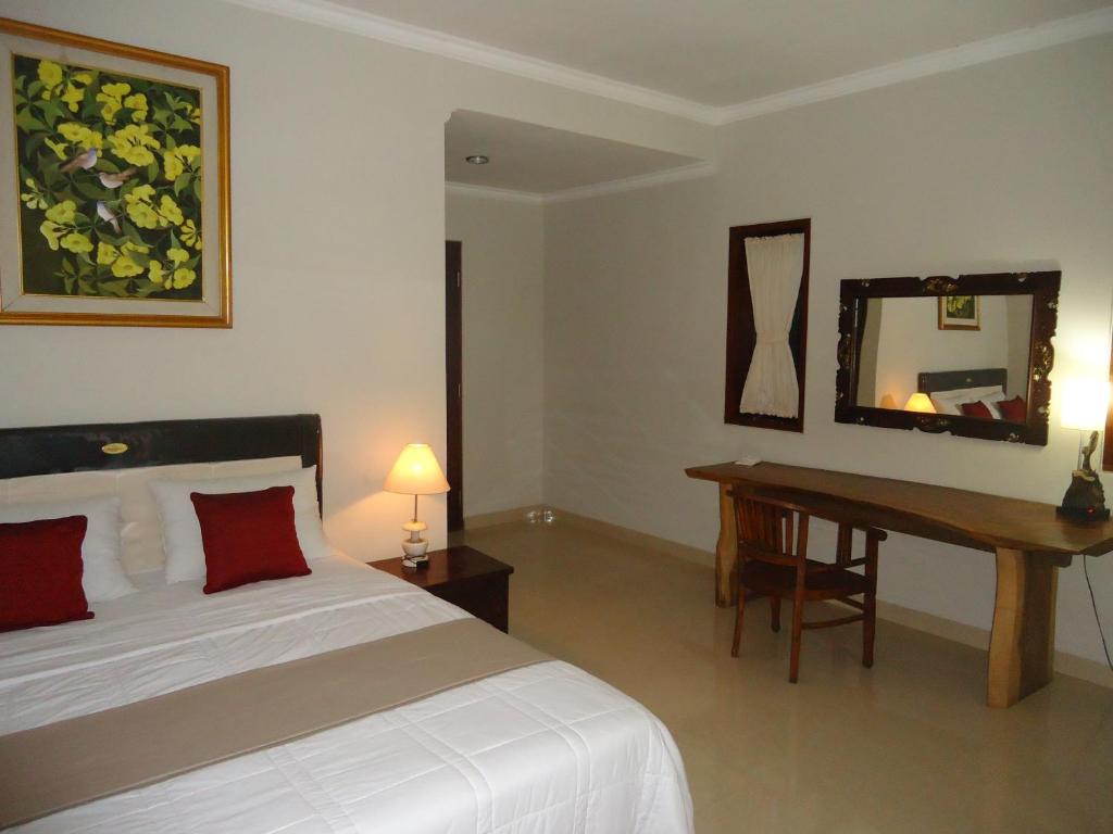 מיטה או מיטות בחדר ב-Dewa Put Guest House