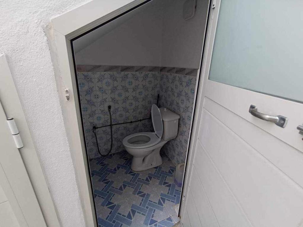 a bathroom with a toilet in a small room at Dar arbi in Kelibia