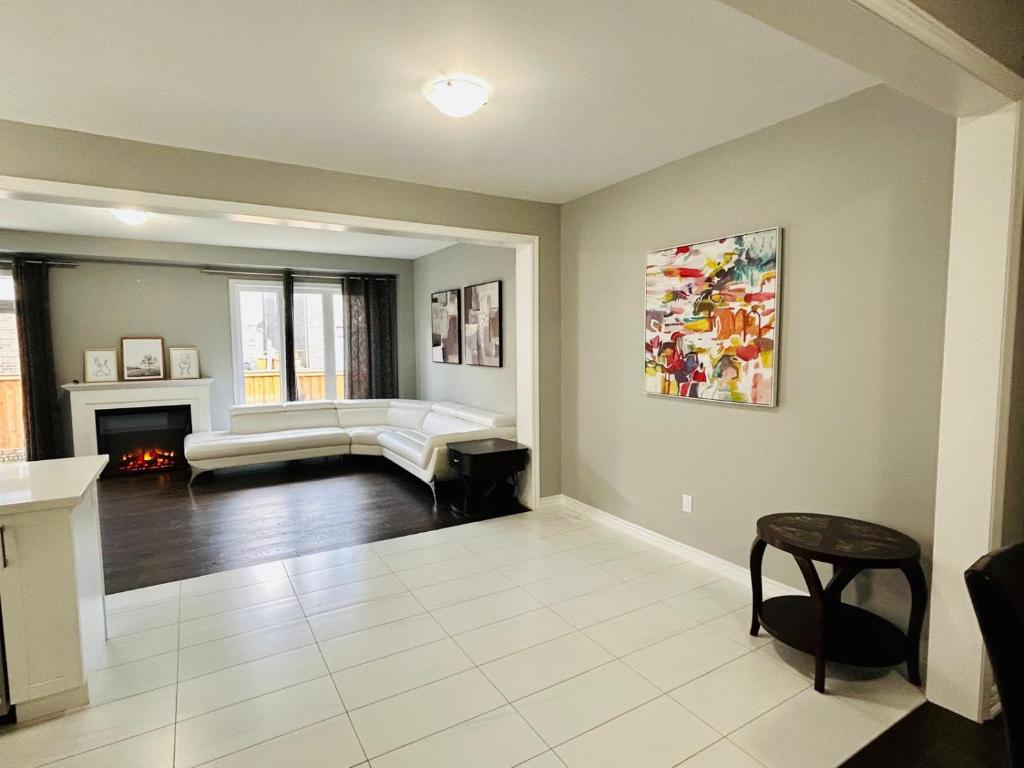 a living room with a couch and a fireplace at The Grand Maple Residence in Brampton