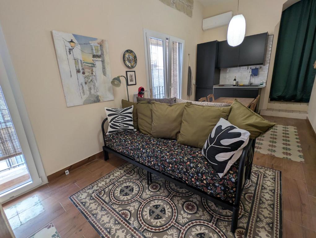 a living room with a couch and a rug at Casa Del Encanto Arcos in Arcos de la Frontera