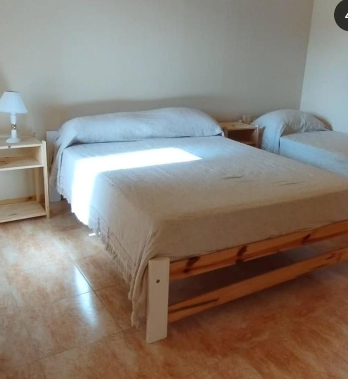 a bedroom with a large bed and a night stand at Villa Sol in San Ignacio