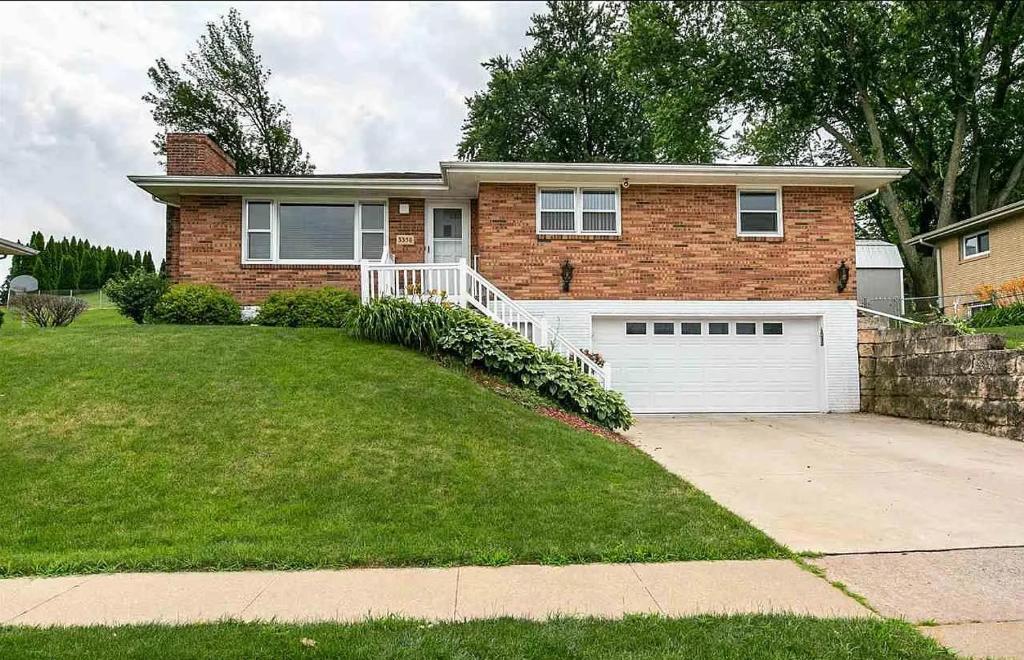 a brick house with a white garage at Dubuque's Hidden Gem! in Dubuque