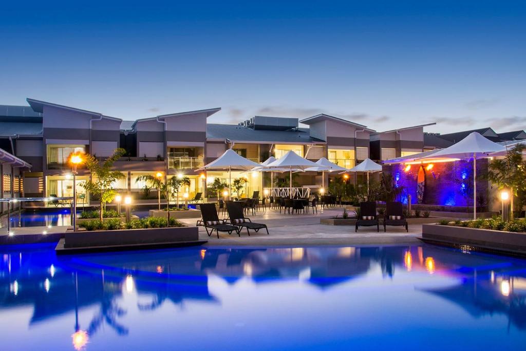 a resort with a swimming pool at night at Lagoons Resort Apartment 63 in Agnes Water