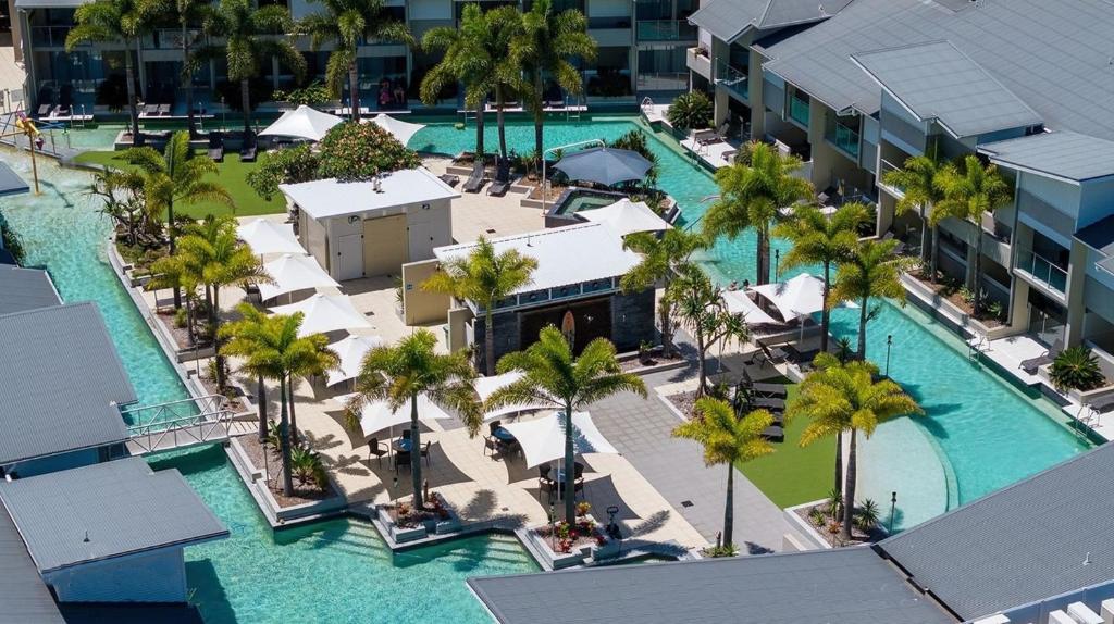an aerial view of a resort with palm trees and a pool at Lagoons Resort Studio 64 in Agnes Water