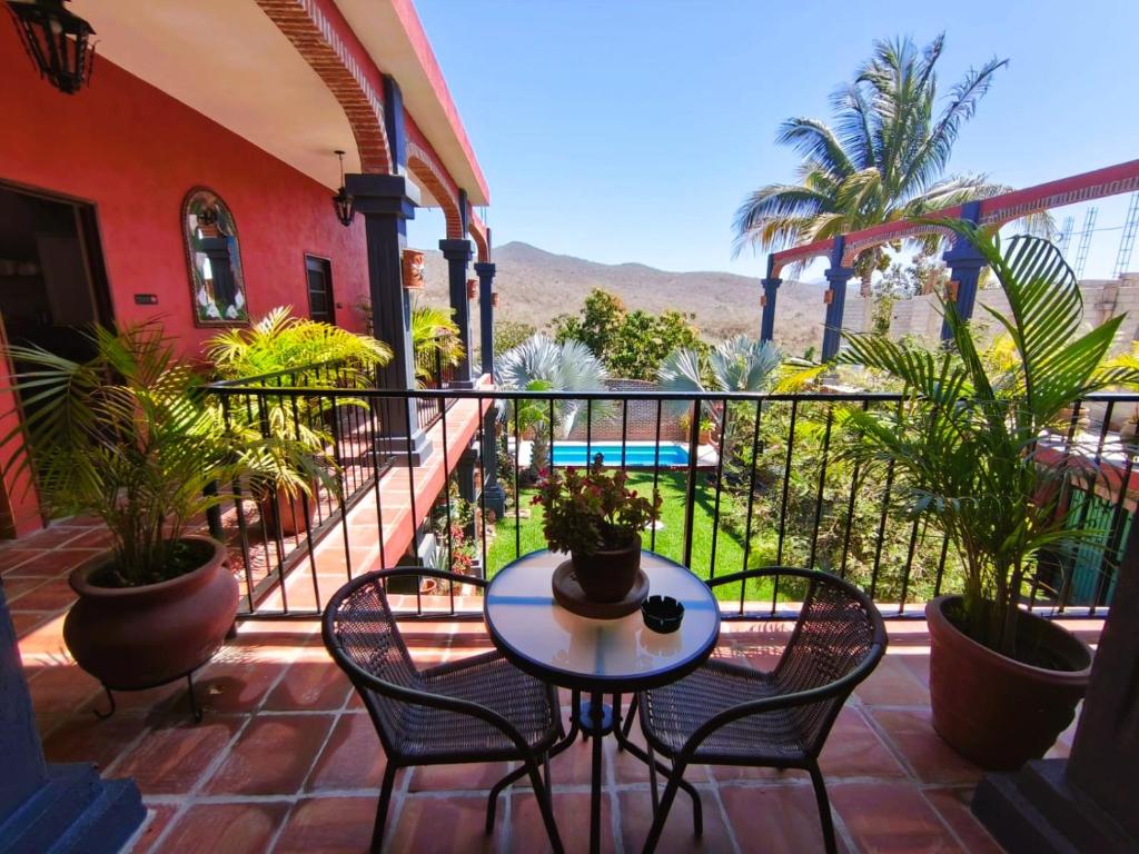 a patio with a table and chairs on a balcony at Casa Punta Perula VILLAS in Pérula