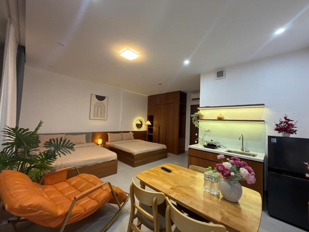 a living room with a bed and a dining table at BEER HOMESTAY Huế - FREE POOL & GYM in Hue