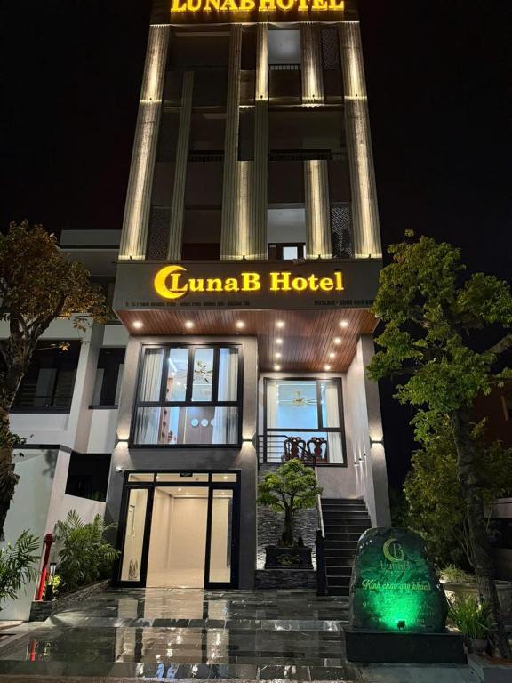 a gujarati hotel with a sign on it at night at LunaB Hotel in Dong Hoi