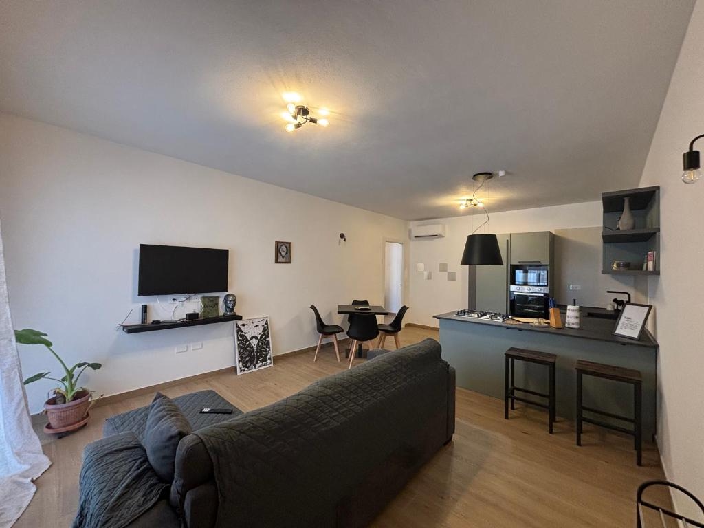 a living room with a couch and a kitchen at Serendipity in Elmas